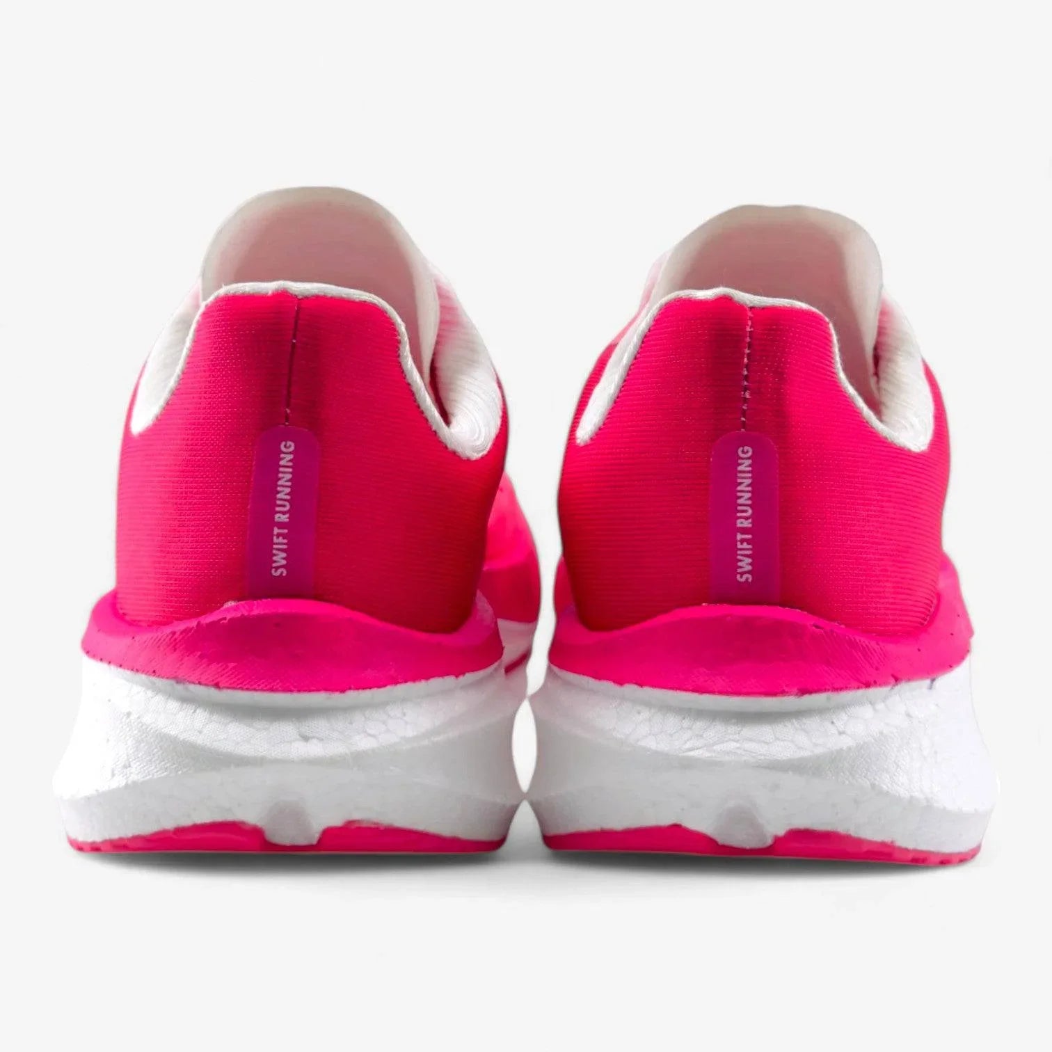 Back view of pink women's running shoes with white soles and 'Swift Running' label