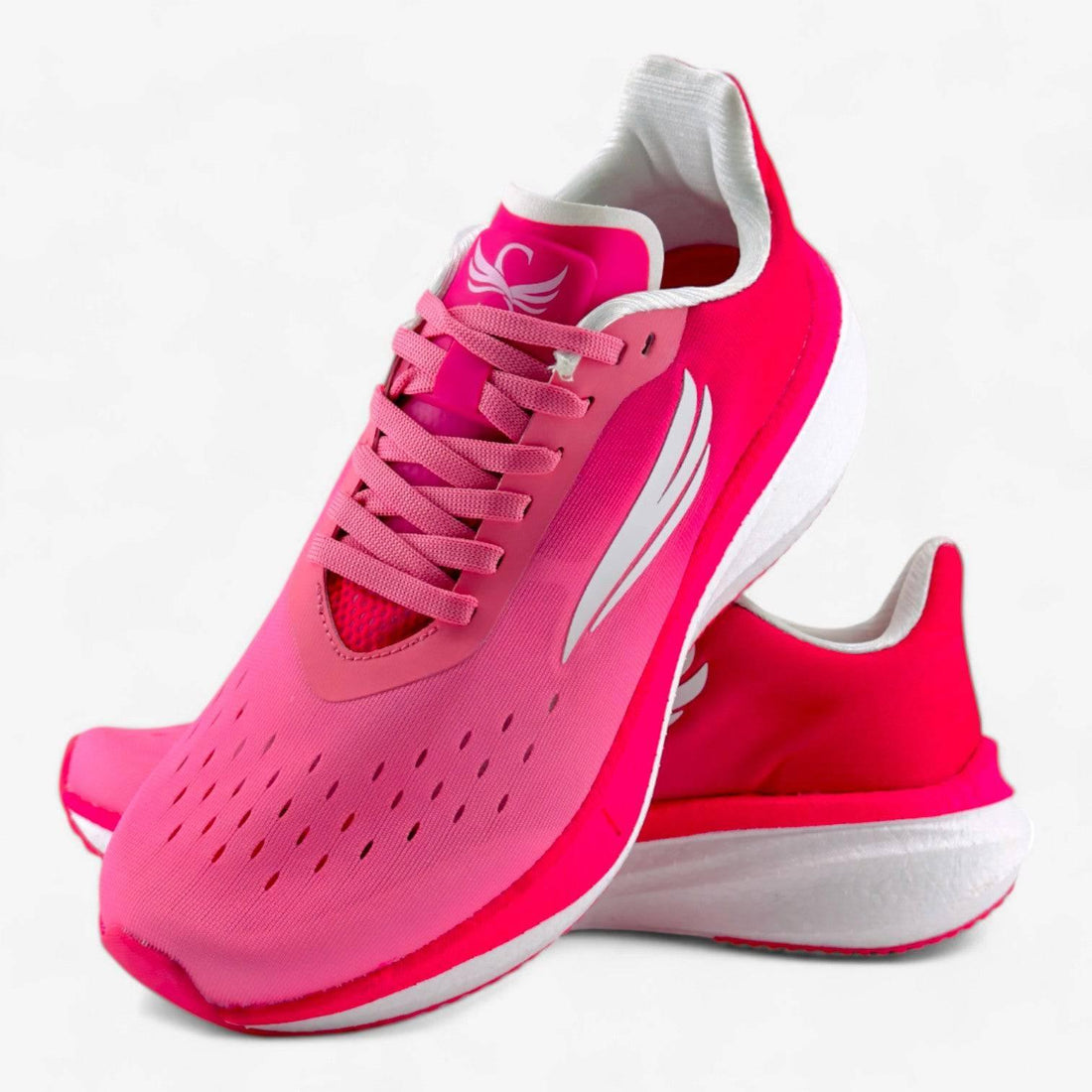 Bright pink women's running shoes with breathable mesh upper and white soles on a white background