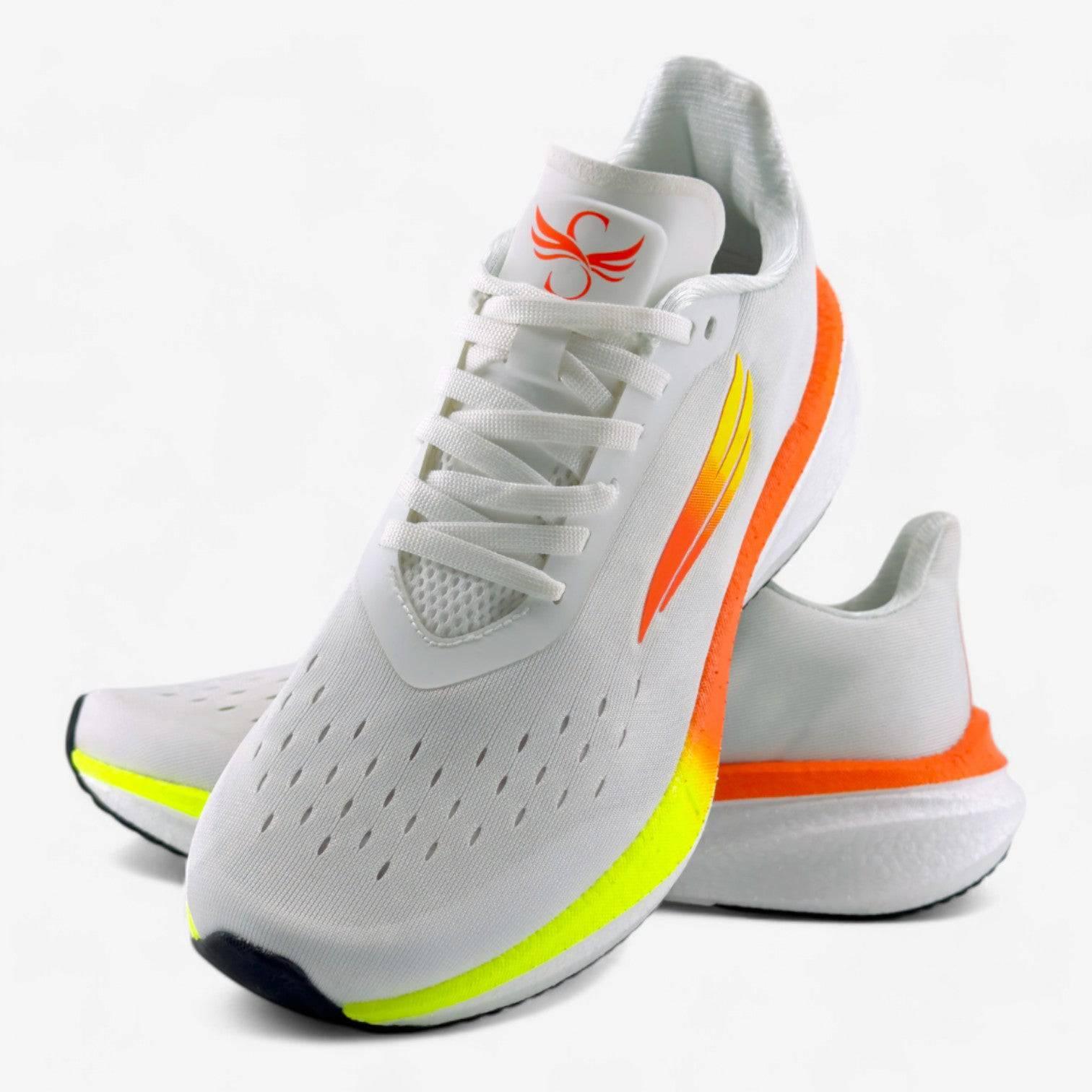 White women's running shoes with orange and yellow accents, cushioned sole, mesh upper