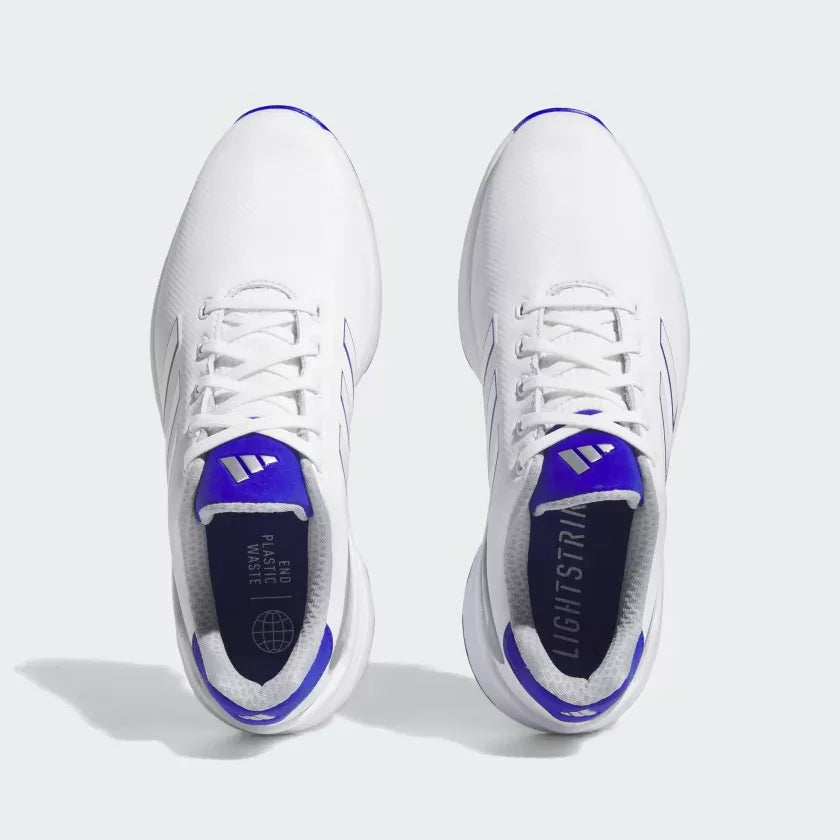 White athletic golf shoes with blue accents, top view, laced up, lightweight design